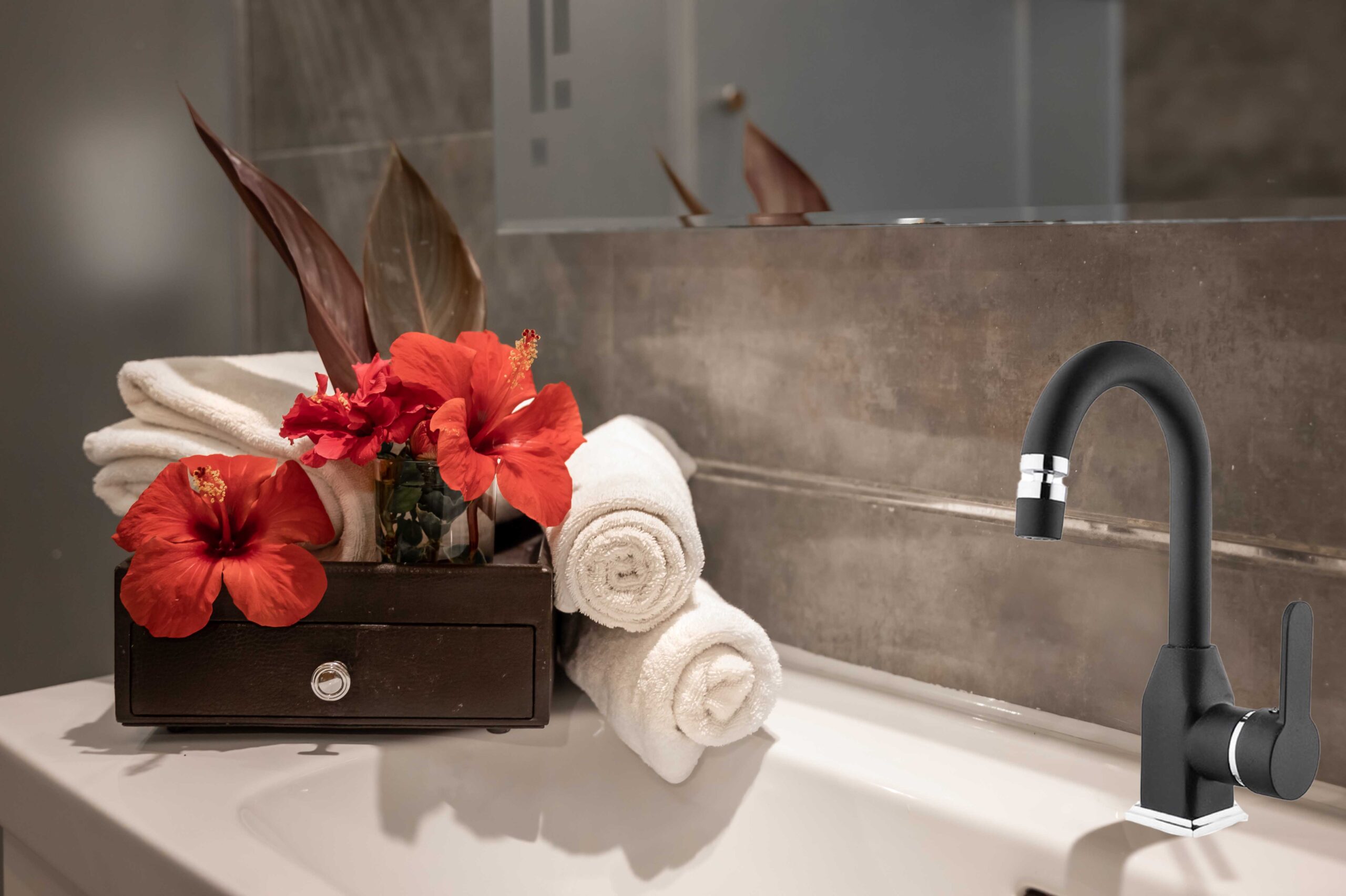 Spa composition with flowers and towels in the bathroom on the washbasin.